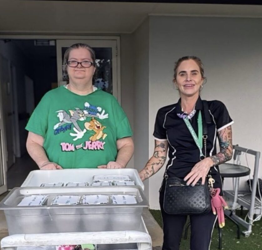 Team member and participant transporting meals for Give Back Thursday